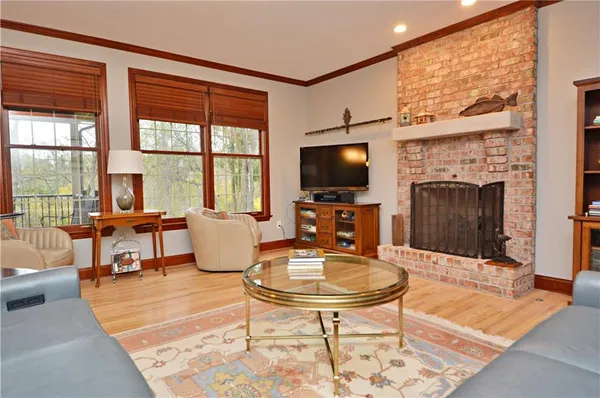 a living room with furniture a fireplace and a flat screen tv