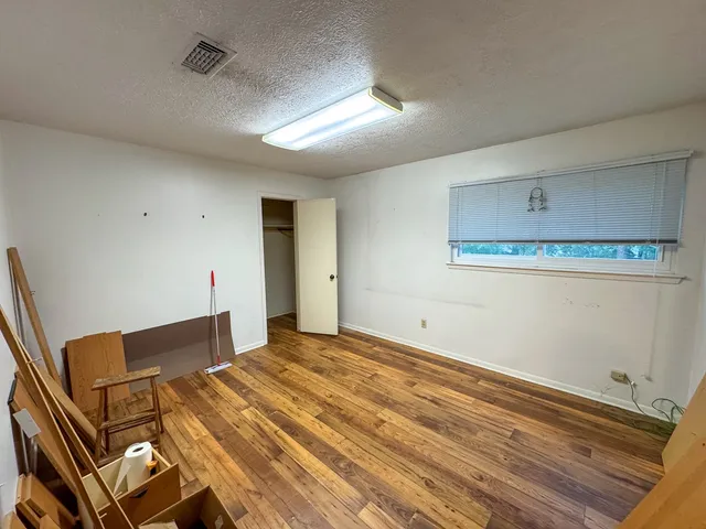 an empty room with a empty space and windows