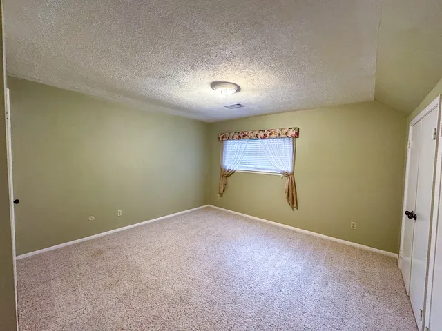 a view of an empty room and a window