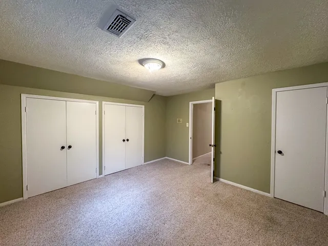 a view of a road with a house in the background