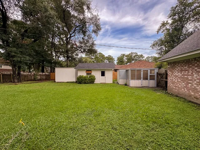 a view of a field of grass and trees