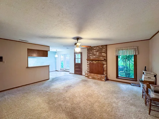 an empty room with furniture and a window