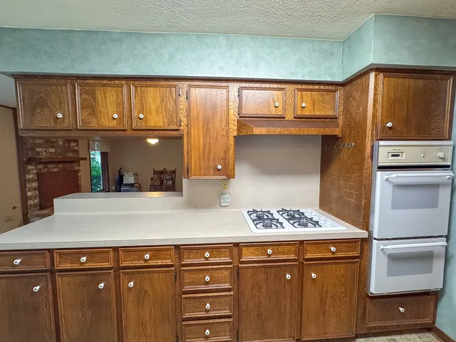 a kitchen with stainless steel appliances granite countertop a refrigerator and a stove