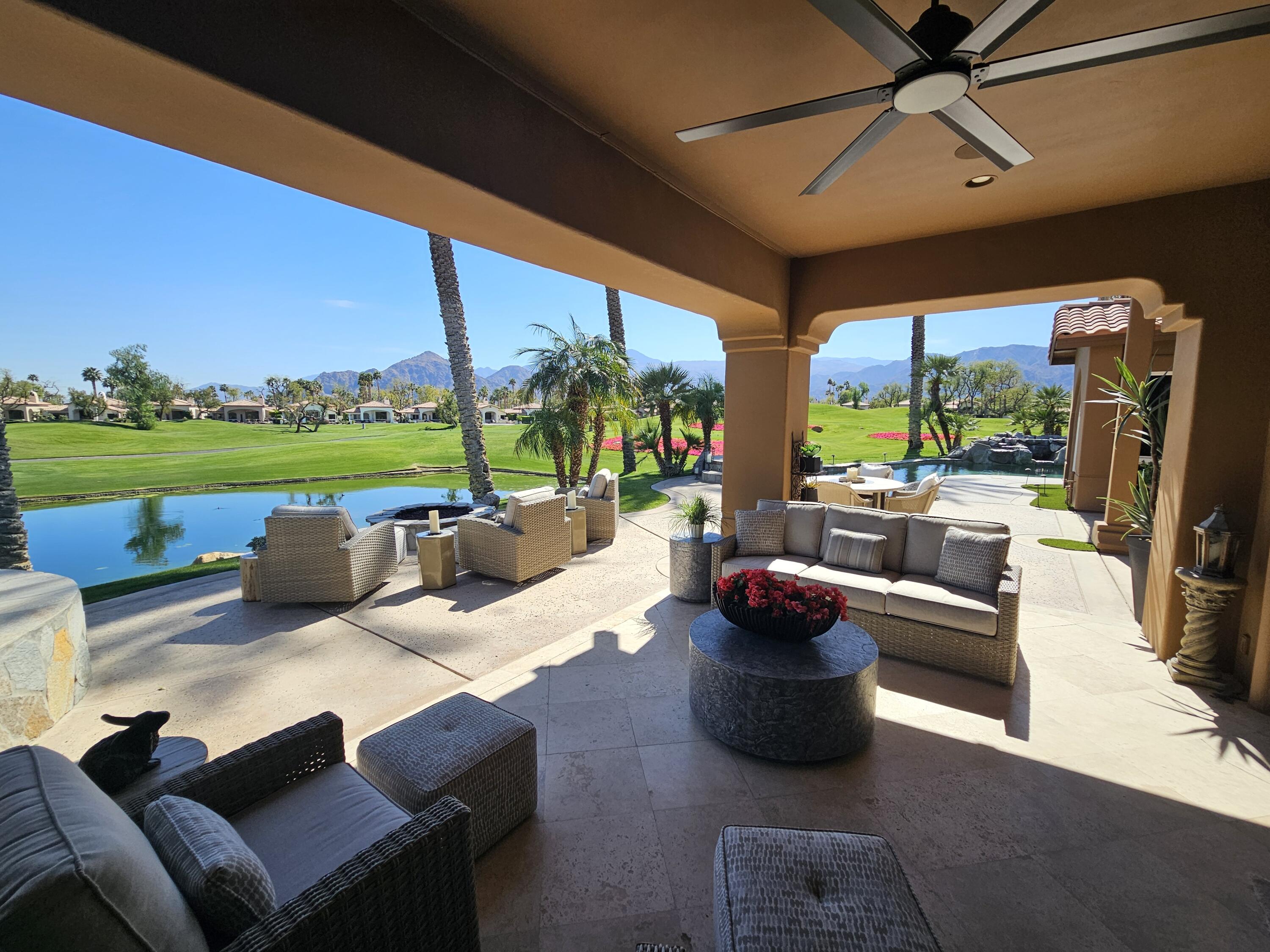 78815 Vía Carmel La Quinta, CA 92253 - Photo 33 of 74 a living room with patio furniture and a floor to ceiling window