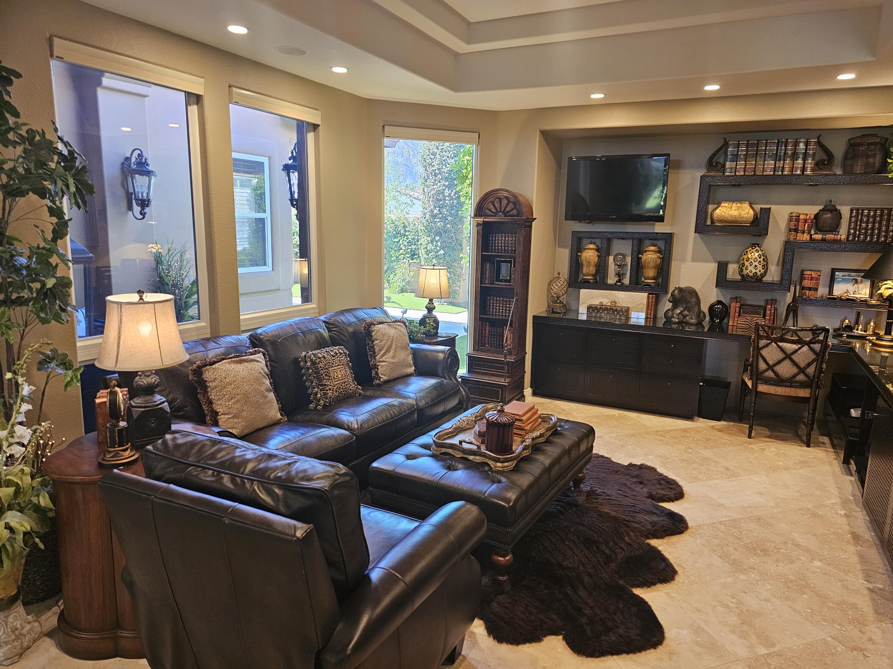 78815 Vía Carmel La Quinta, CA 92253 - Photo 39 of 74 a living room with furniture and a flat screen tv