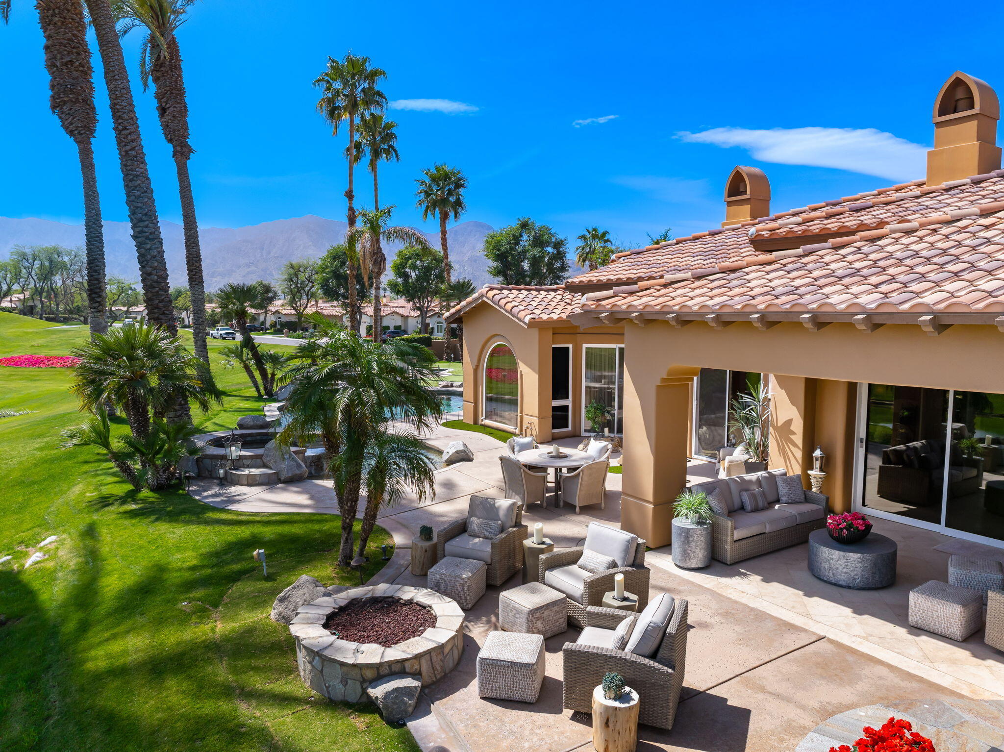 78815 Vía Carmel La Quinta, CA 92253 - Photo 6 of 74 a view of a patio with couches table and chairs potted plants and palm tree