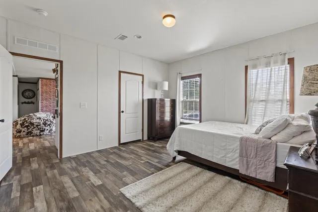 a utility room with wooden floor washer and dryer