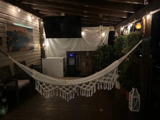 a backyard of a house with a yard and outdoor seating