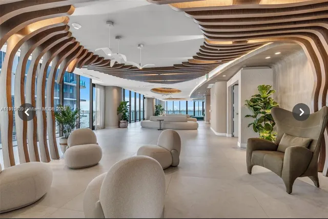a living room with furniture and plants