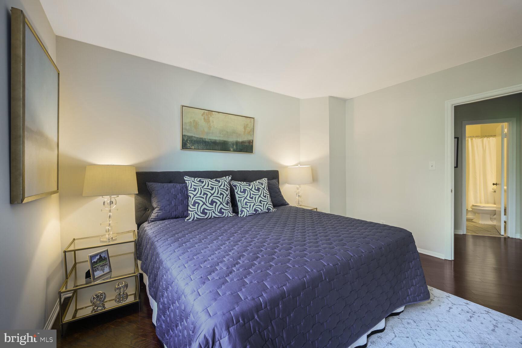 2001 16th Street Northwest, Unit 203 Washington, DC 20009 - Photo 11 of 15 a large bed sitting in a bedroom next to a window