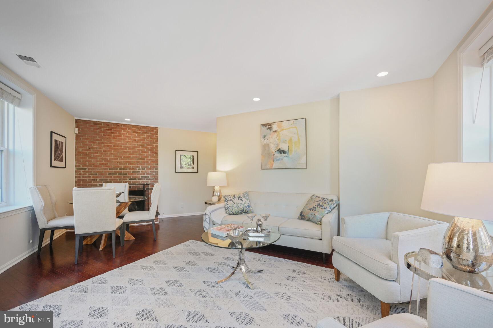 2001 16th Street Northwest, Unit 203 Washington, DC 20009 - Photo 2 of 15 a living room with furniture a table and a window