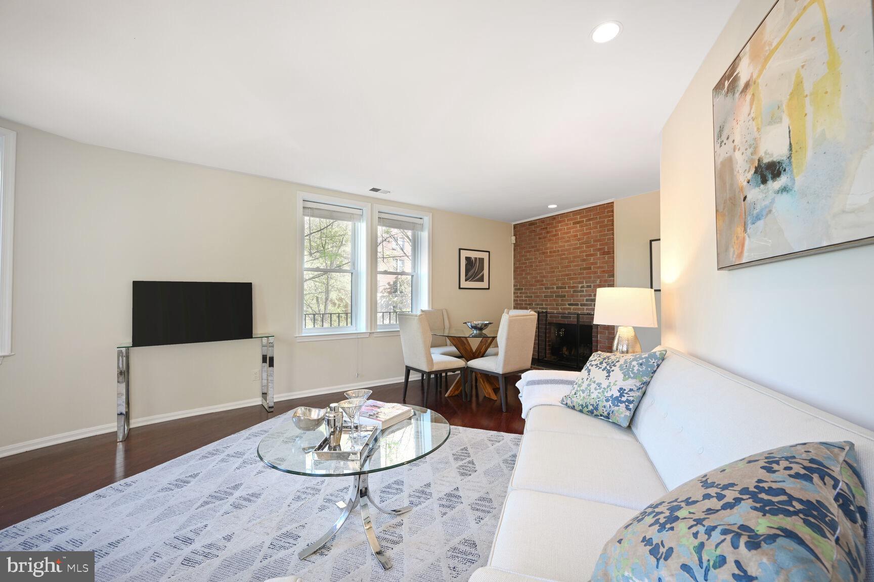 2001 16th Street Northwest, Unit 203 Washington, DC 20009 - Photo 3 of 15 a living room with furniture and a flat screen tv
