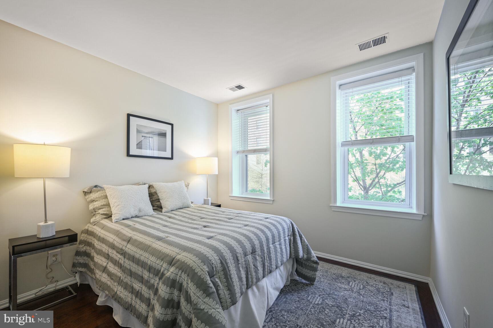 2001 16th Street Northwest, Unit 203 Washington, DC 20009 - Photo 8 of 15 a bedroom with a bed and a window