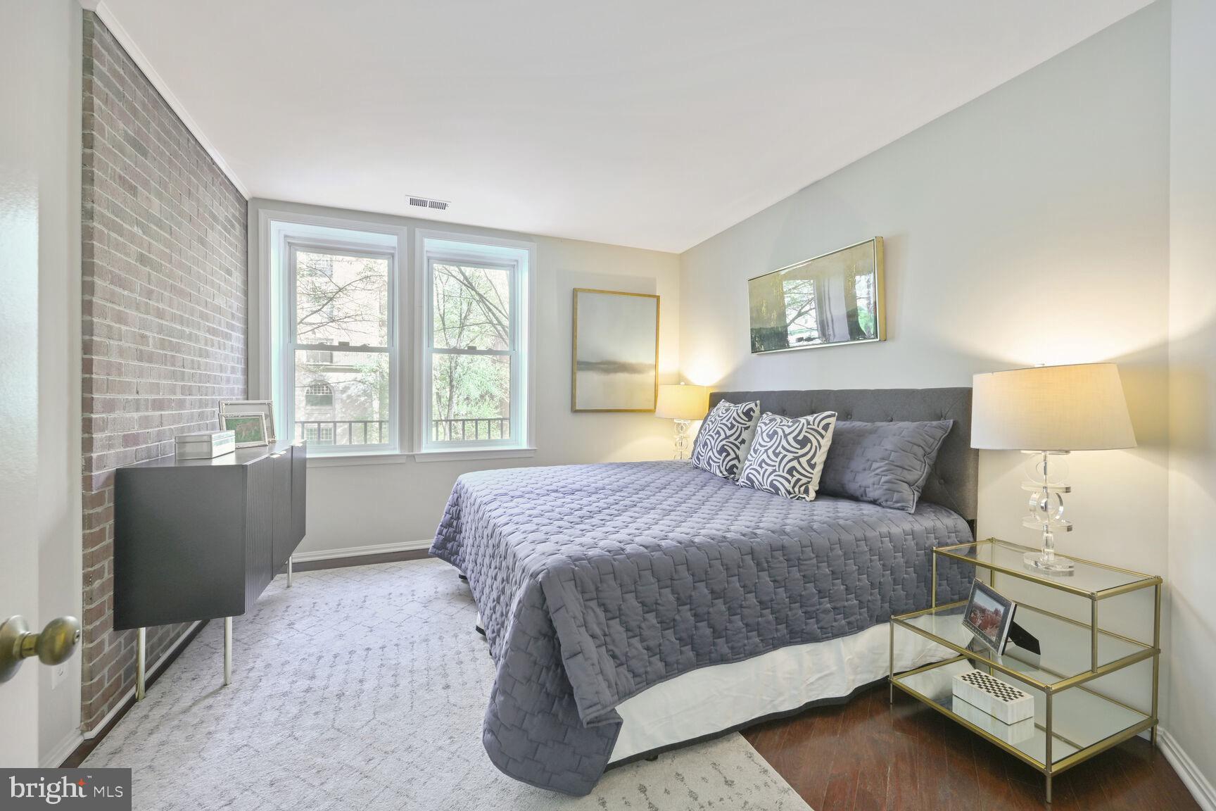 2001 16th Street Northwest, Unit 203 Washington, DC 20009 - Photo 10 of 15 a bedroom with a bed and a couch