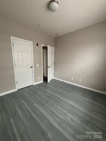 a view of room with wooden floor