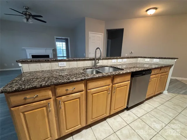 a sink with granite countertop cabinets and sink