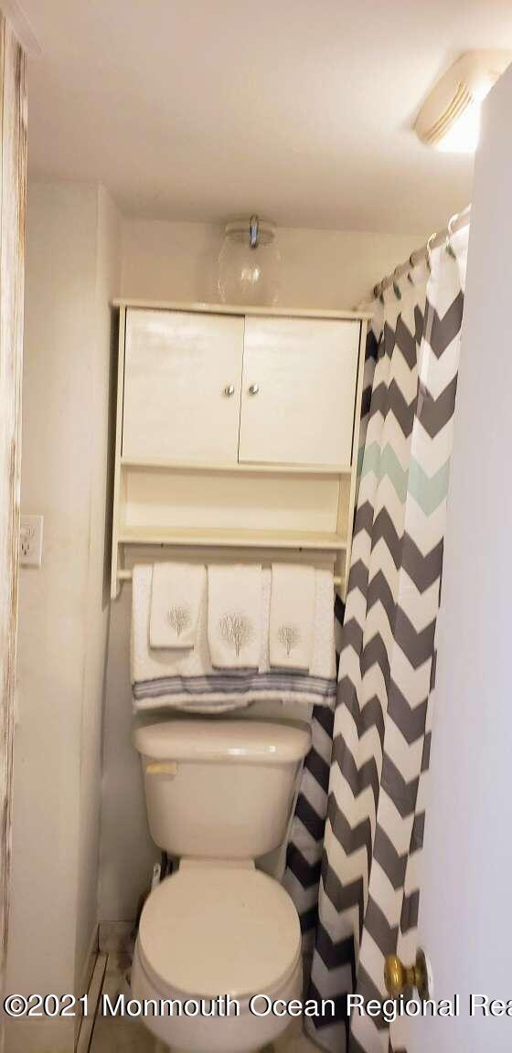 39 Dock Road Brick, NJ 08723 - Photo 22 of 23 a white toilet sitting next to a shower curtain