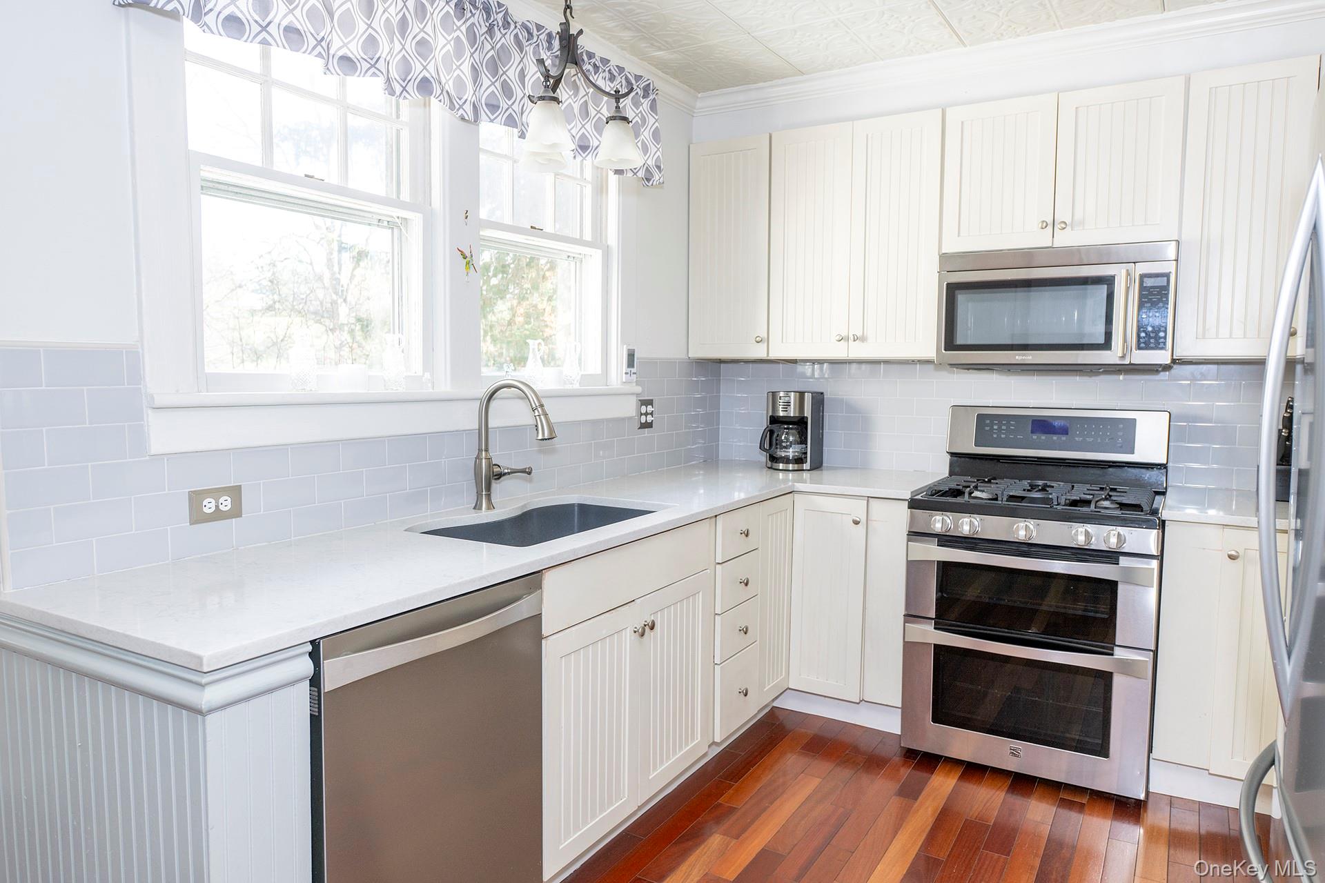 145 Drake Road Pleasant Valley, NY 12569 - Photo 5 of 47 a kitchen with stainless steel appliances white cabinets a sink and a stove