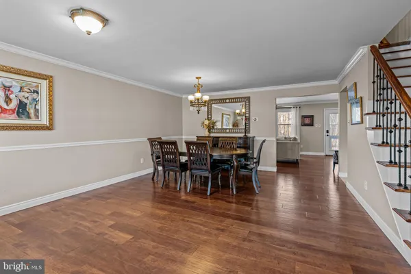 a view of a dining room with furniture and chandelier
