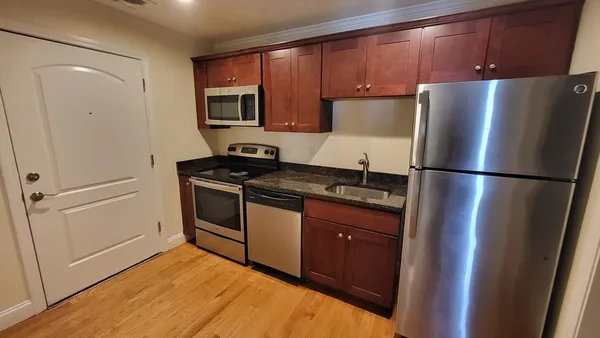 a kitchen with a refrigerator and a sink