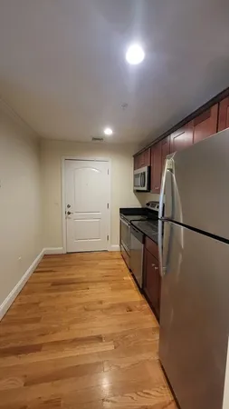 a view of kitchen with refrigerator microwave and wooden floor