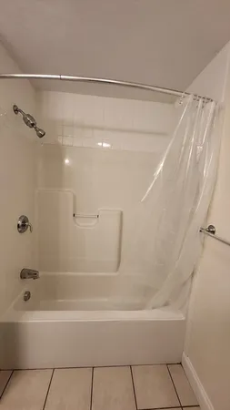 a bathroom with a shower and a bath tub