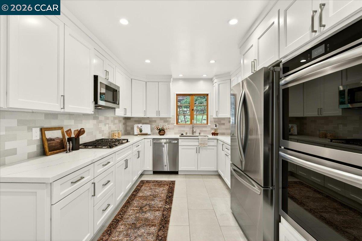 24 Las Vegas Road Orinda, CA 94563 - Photo 13 of 47 a kitchen with granite countertop a refrigerator stove and microwave