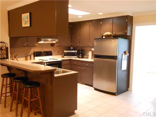 741 Gold Sand Road Louisburg, NC 27549 - Photo 7 of 25 Kitchen breakfast bar and tile flooring