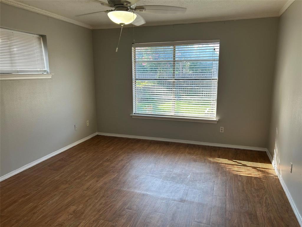 7458 Walling Lane Dallas, TX 75231 - Photo 4 of 10 a view of an empty room with wooden floor and a window