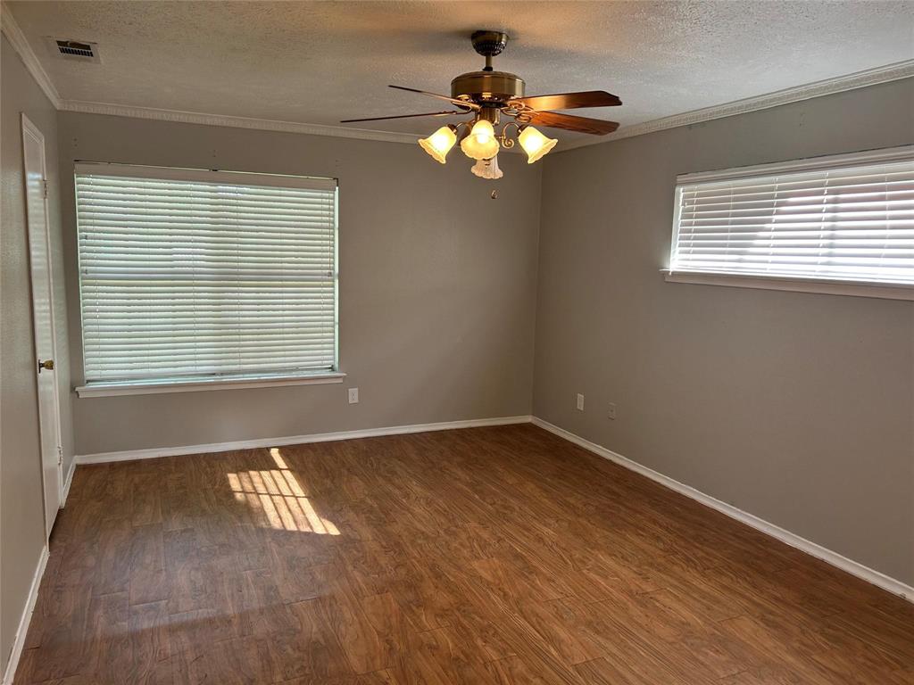 7458 Walling Lane Dallas, TX 75231 - Photo 6 of 10 a view of an empty room with wooden floor and a window
