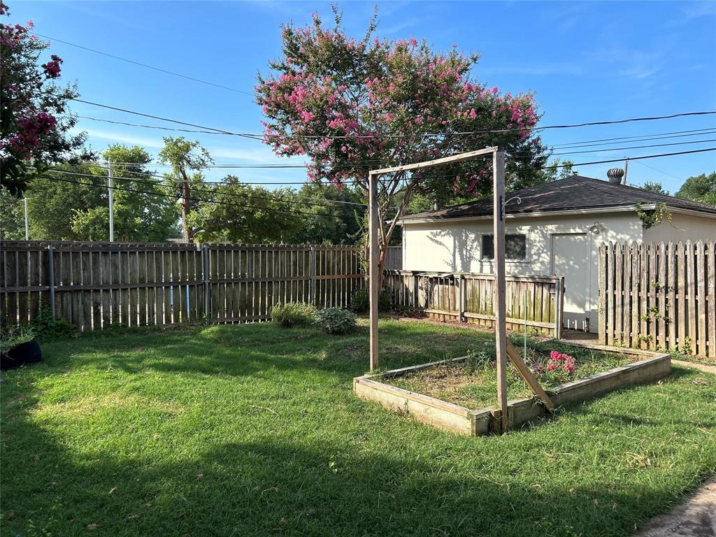 7458 Walling Lane Dallas, TX 75231 - Photo 8 of 10 a view of a backyard with a small cabin