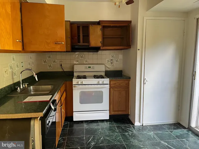 a kitchen with a sink stove and microwave