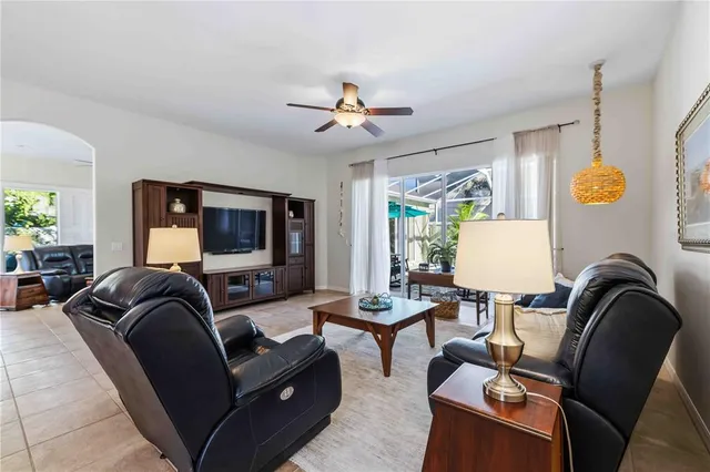 a kitchen with stainless steel appliances granite countertop a stove top oven a sink a dining table and chairs with wooden floor