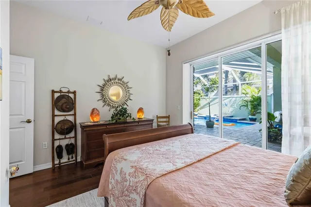 a bedroom with a bed a dresser and window