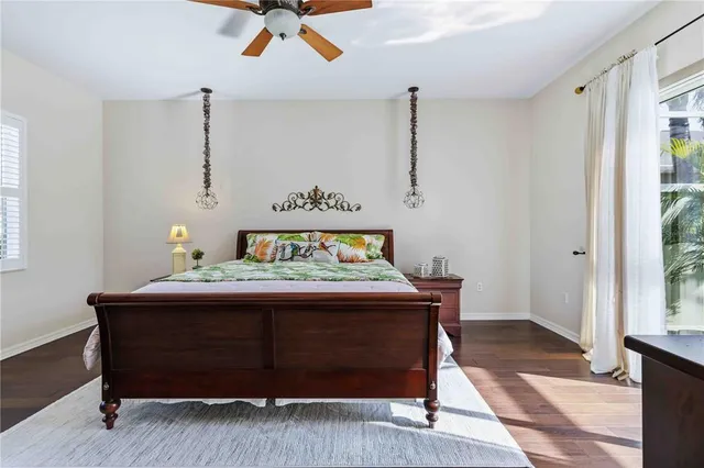 a bedroom with a bed mirror furniture and a flat screen tv