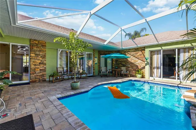 a view of a patio with a table and chairs under an umbrella