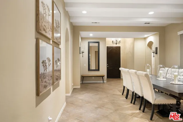 a view of a hallway with furniture and a bathroom