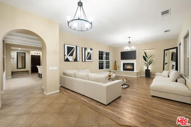a living room with furniture and a chandelier
