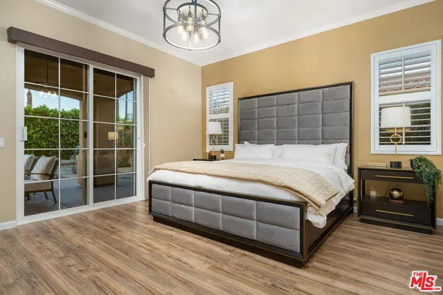 a large bed sitting in a bedroom next to a window