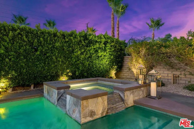 a view of a backyard with swimming pool