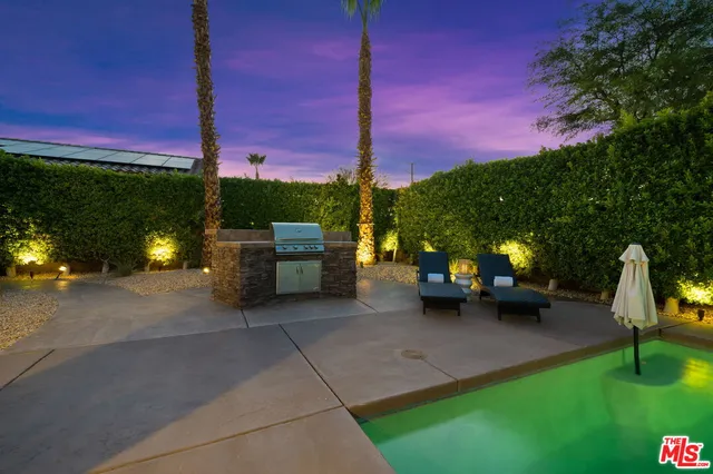 a view of a patio with a table and chairs and a fire pit