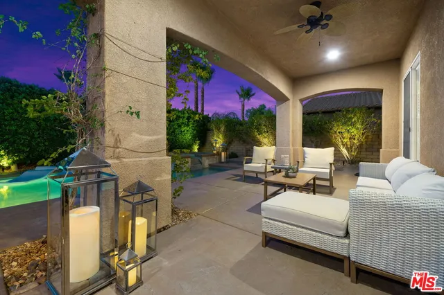 a living room with furniture a lamp and a table