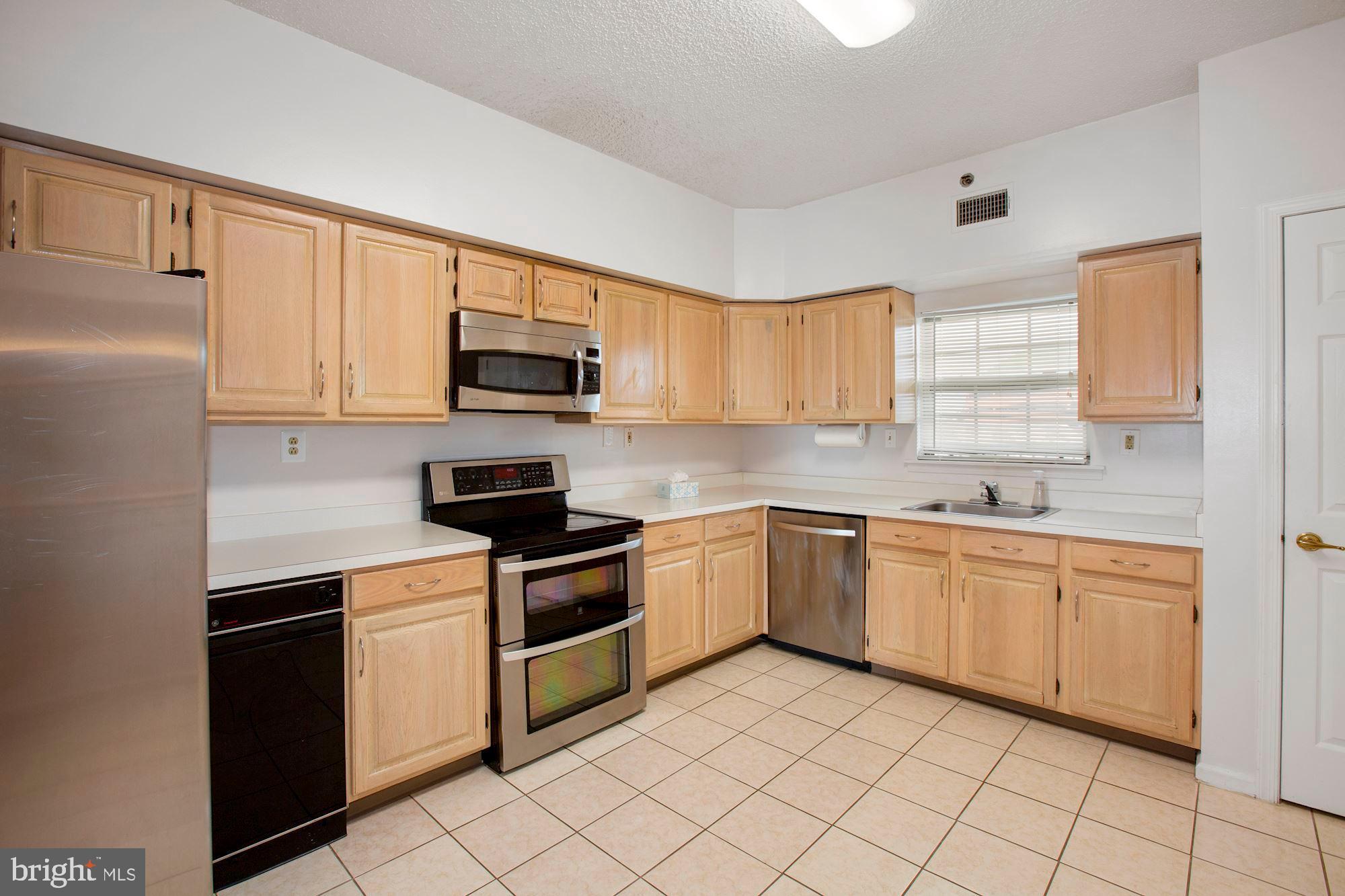 6250 Main Street Voorhees, NJ 08043 - Photo 8 of 28 a kitchen with granite countertop white cabinets and stainless steel appliances