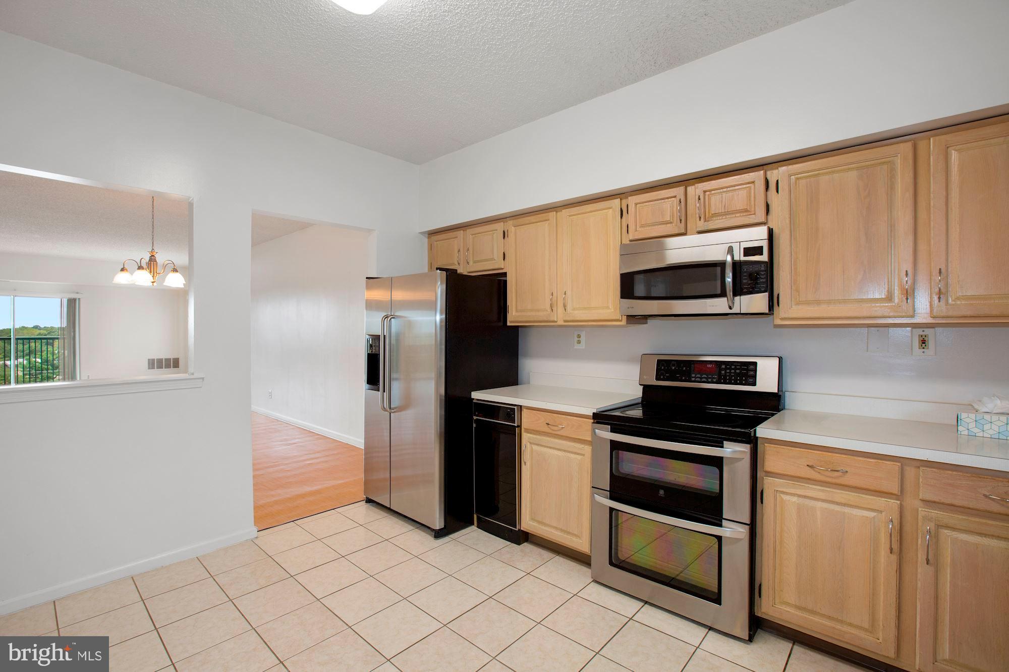 6250 Main Street Voorhees, NJ 08043 - Photo 9 of 28 a kitchen with stainless steel appliances a stove a sink and a microwave