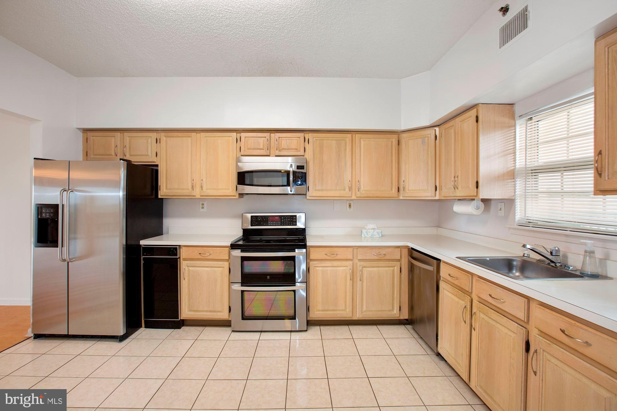 6250 Main Street Voorhees, NJ 08043 - Photo 10 of 28 a kitchen with stainless steel appliances a refrigerator sink and microwave