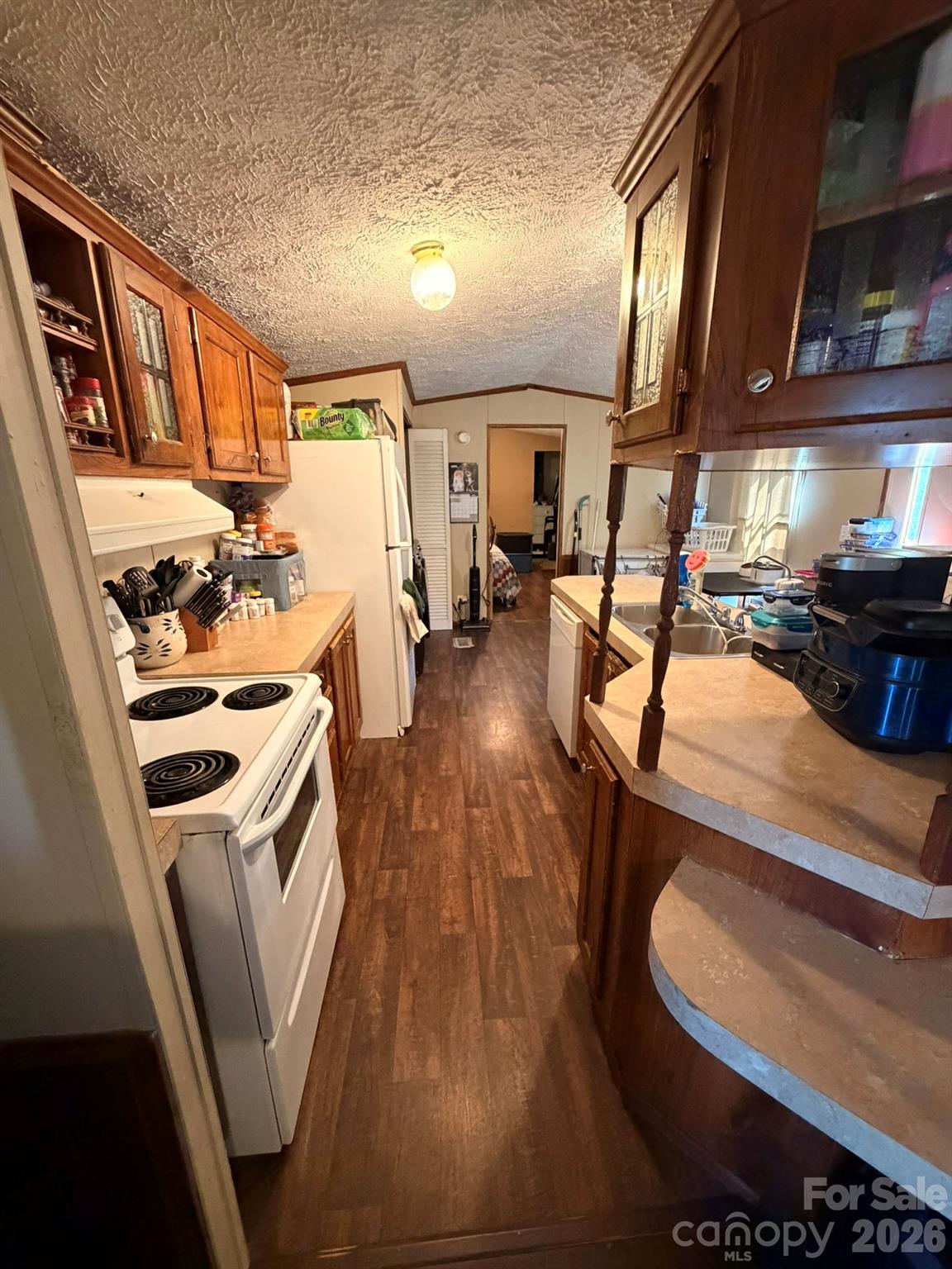 401 Webb Church Road Ellenboro, NC 28040 - Photo 9 of 21 a room with wooden floors and white appliances