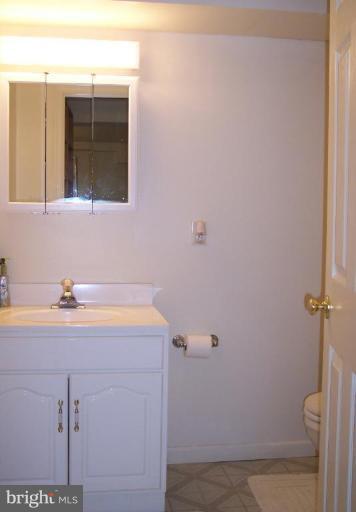 2319 Farringdon Road Baltimore, MD 21209 - Photo 14 of 16 a bathroom with a sink and a mirror
