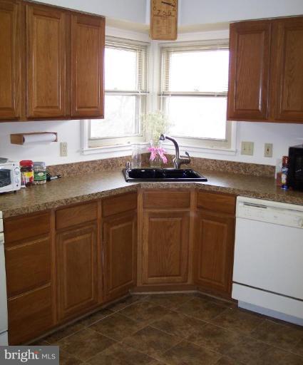 2319 Farringdon Road Baltimore, MD 21209 - Photo 3 of 16 a kitchen with granite countertop a sink window and cabinets