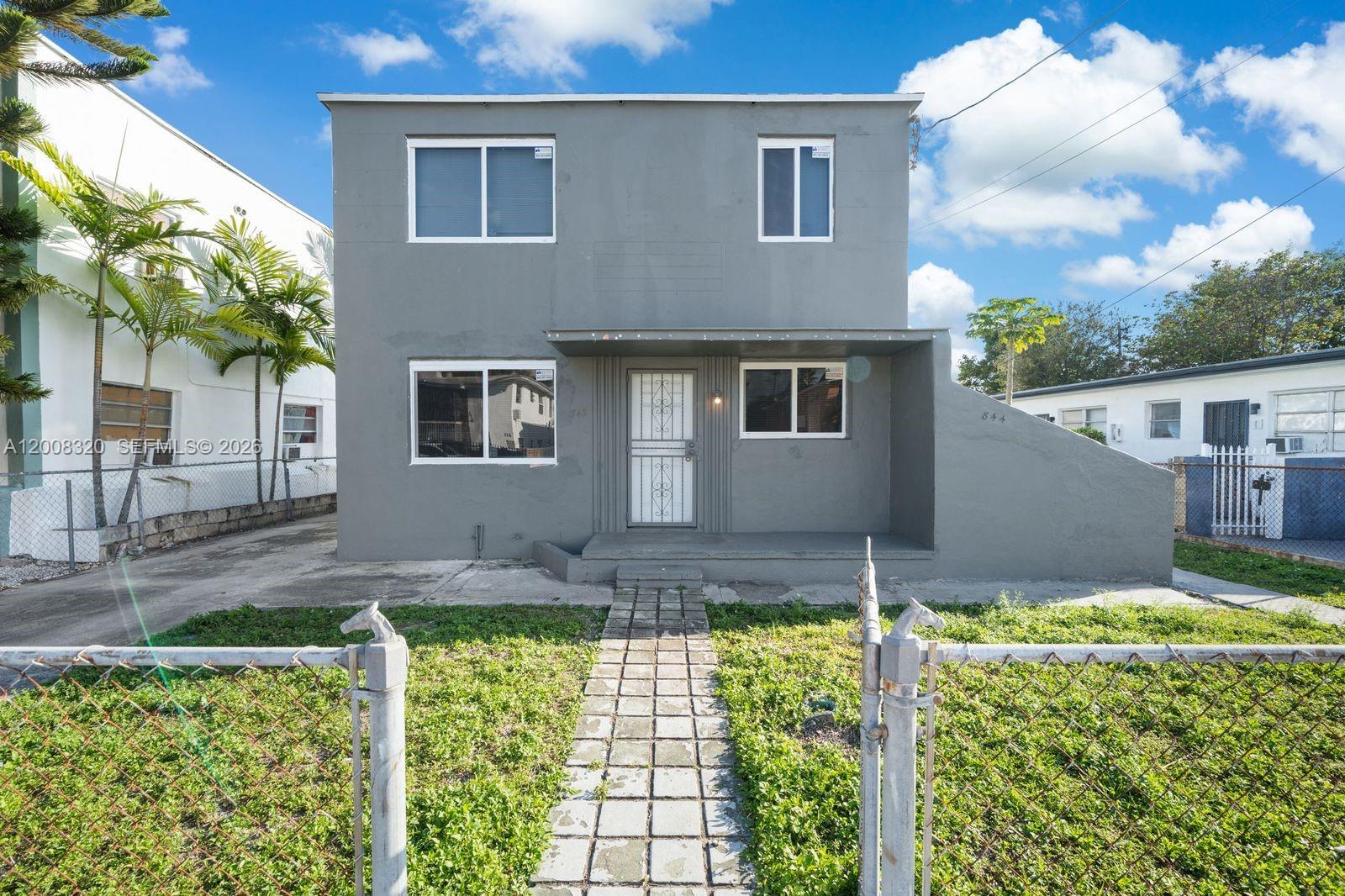 842 Southwest 3rd Street Miami, FL 33130 - Photo 1 of 13 a front view of a house with a yard