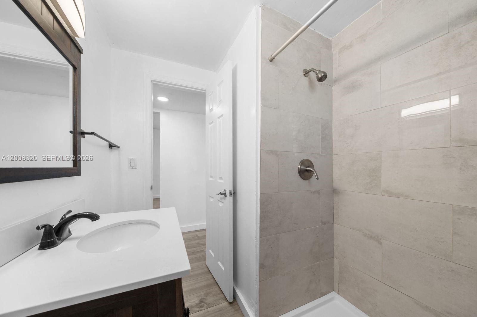 842 Southwest 3rd Street Miami, FL 33130 - Photo 11 of 13 a bathroom with a sink shower and a mirror